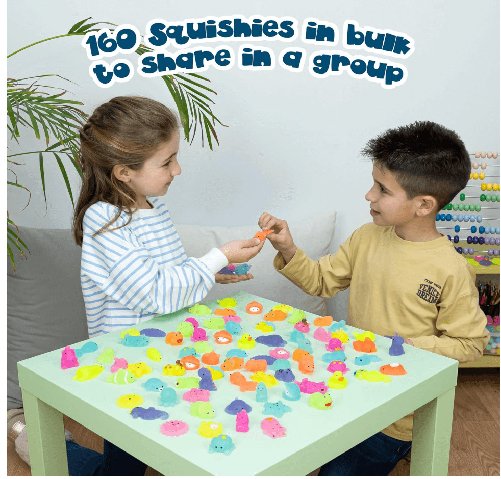MONKY 80 Mochi Squishy Toys being shared by kids at a table filled with colorful squishies.