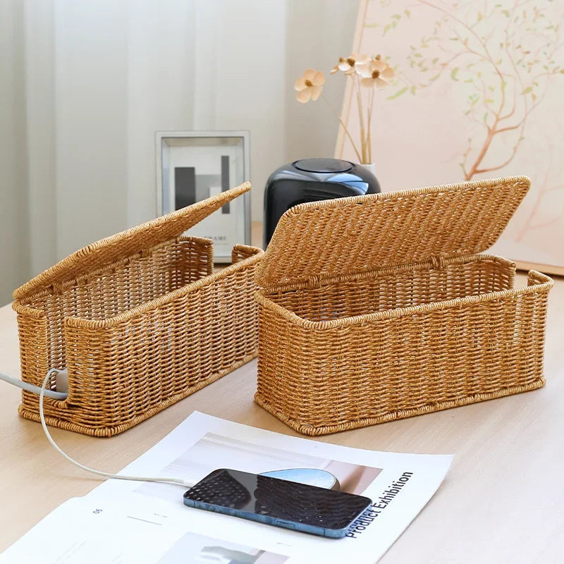 Handmade rattan wire management box on desk, perfect for keeping cords organized and workspace tidy.