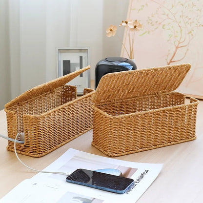 Handmade rattan wire management box on desk, perfect for keeping cords organized and workspace tidy.