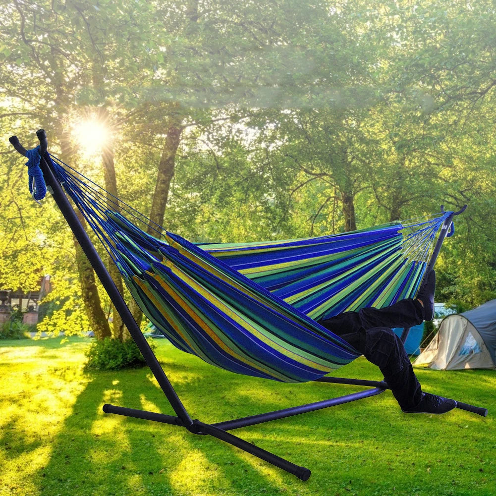 Double Hammock w/Stand, 2-People Hammock & Stand in a sunny outdoor setting with a person relaxing.