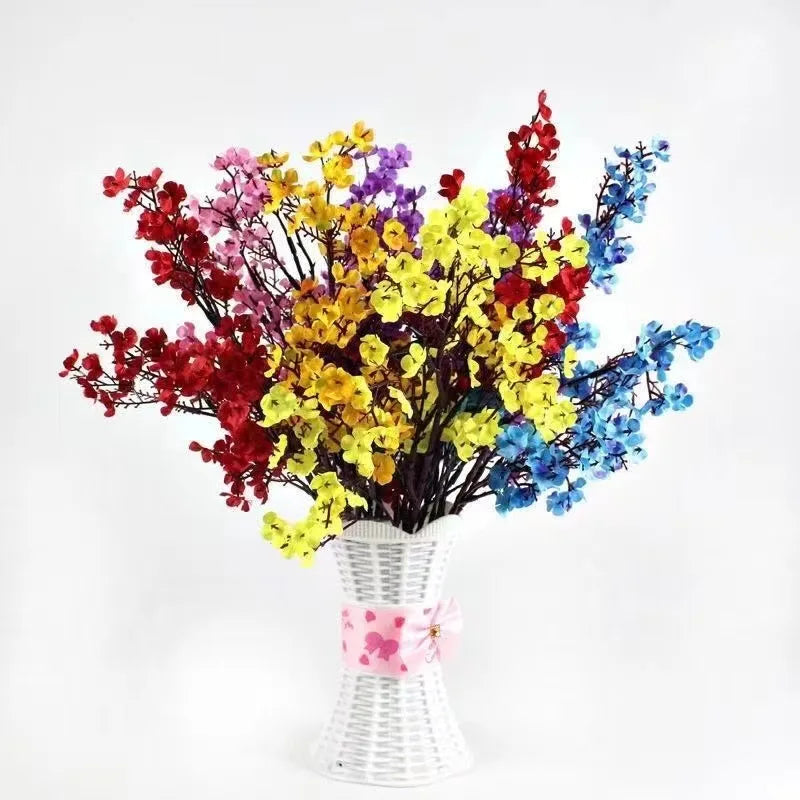 Beautiful home bouquet featuring multicolor artificial sakura flowers in a decorative vase.