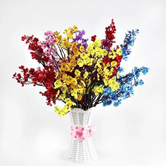 Beautiful home bouquet featuring multicolor artificial sakura flowers in a decorative vase.