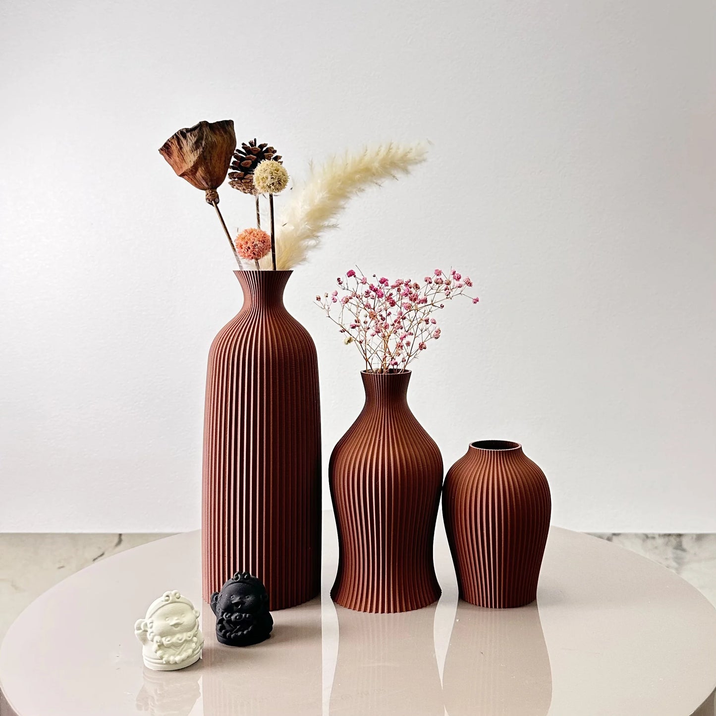 3-Piece Set of Artistic Decorative Vases Elegant Vase displaying dried flowers on a round table.