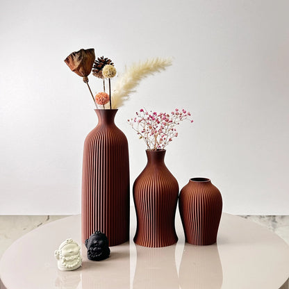 3-Piece Set of Artistic Decorative Vases Elegant Vase displaying dried flowers on a round table.