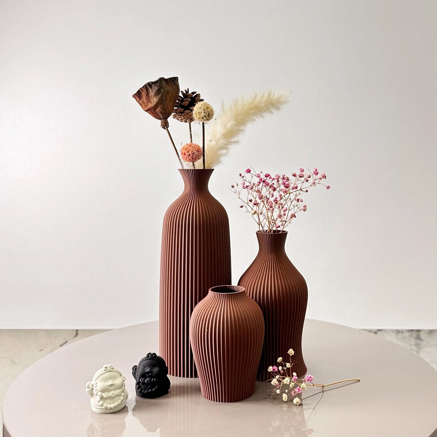3-Piece Set of Artistic Decorative Vases Elegant Vase with dried flowers and ornaments on a table.